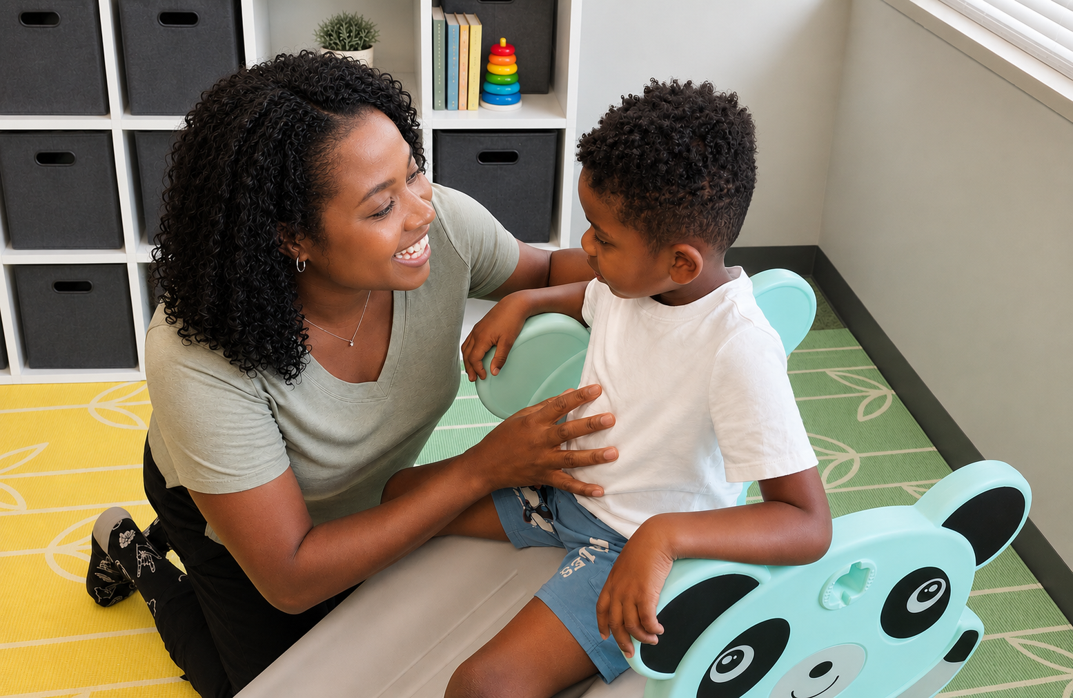 A pediatric therapist working with a child in a welcoming therapy space